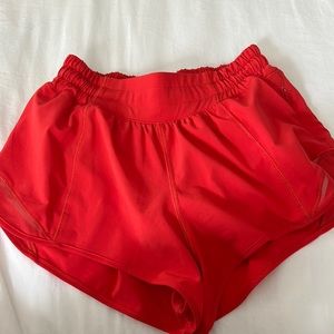 Lululemon athletic shorts size 2 2.5. carnation, red low rise.